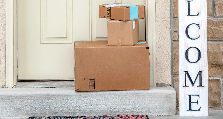 Packages on the doorstep of a home with a welcome sign in Bellingham